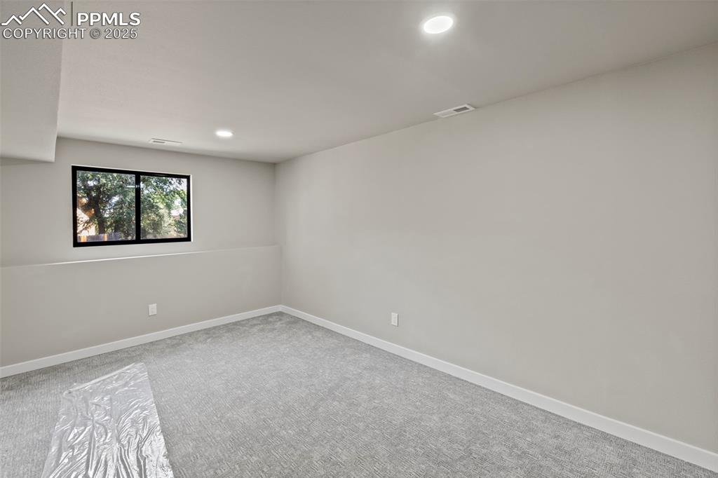 Image 41 of 50: Unfurnished room with light colored carpet and recessed lighting