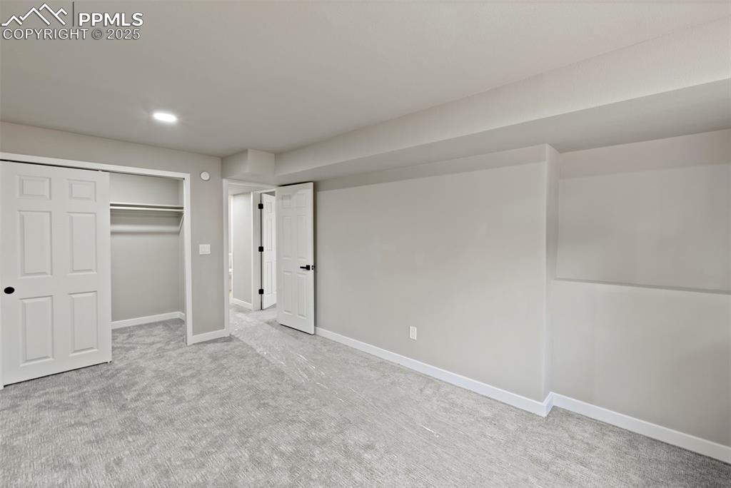 Image 43 of 50: Unfurnished bedroom featuring a closet, carpet, and recessed lighting