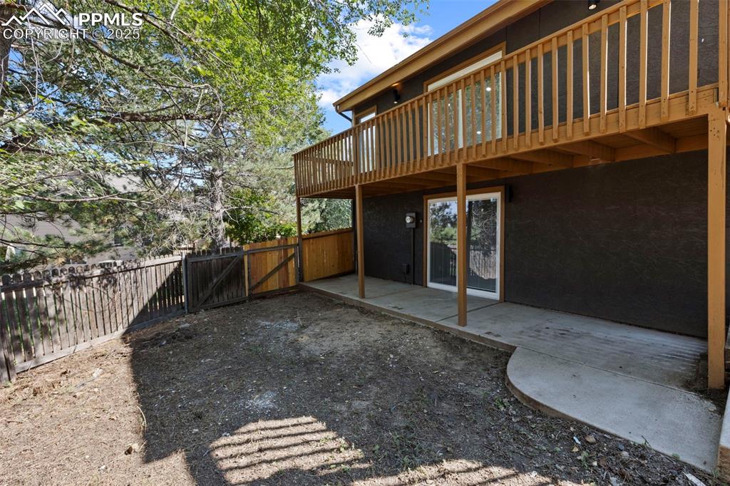 Image 48 of 50: Rear view of property with a patio area, a gate, and a balcony