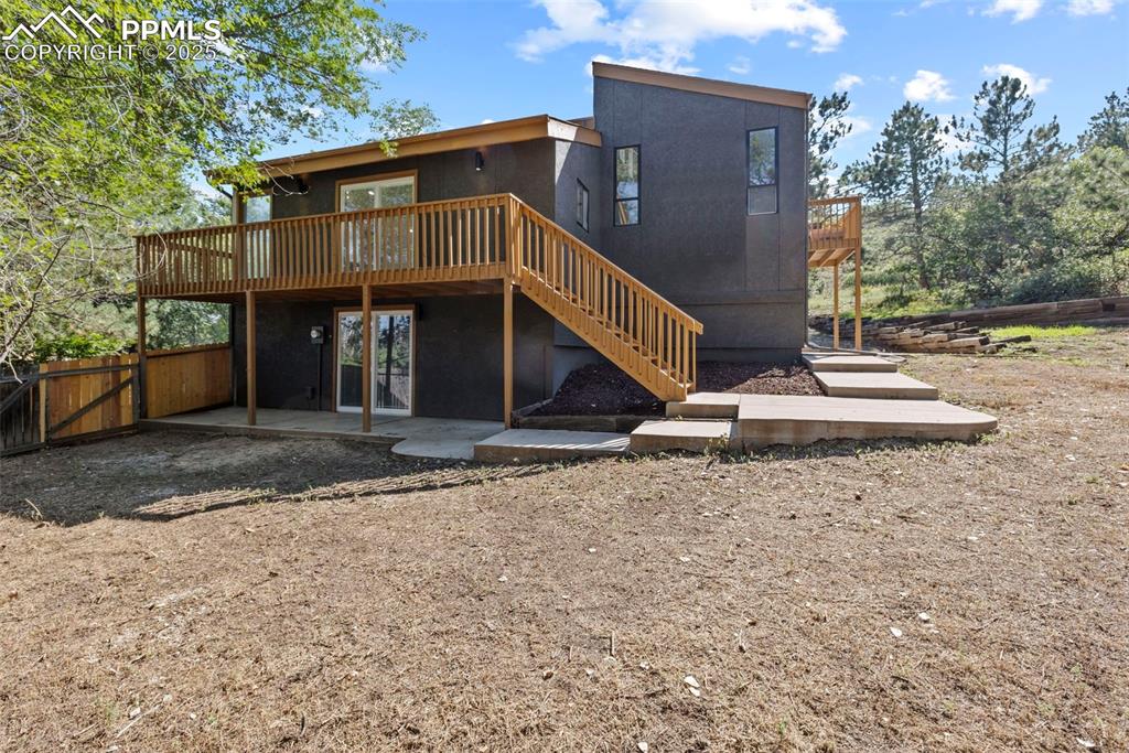 Image 49 of 50: Rear view of property with a deck, a patio area, and stairs
