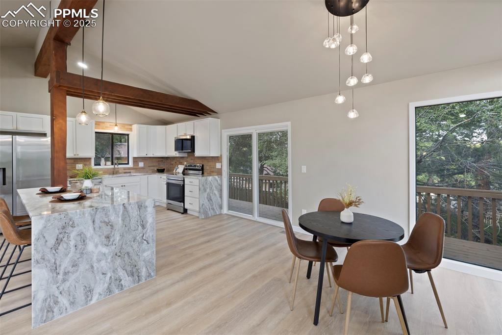 Image 7 of 50: Dining room with light wood-type flooring
