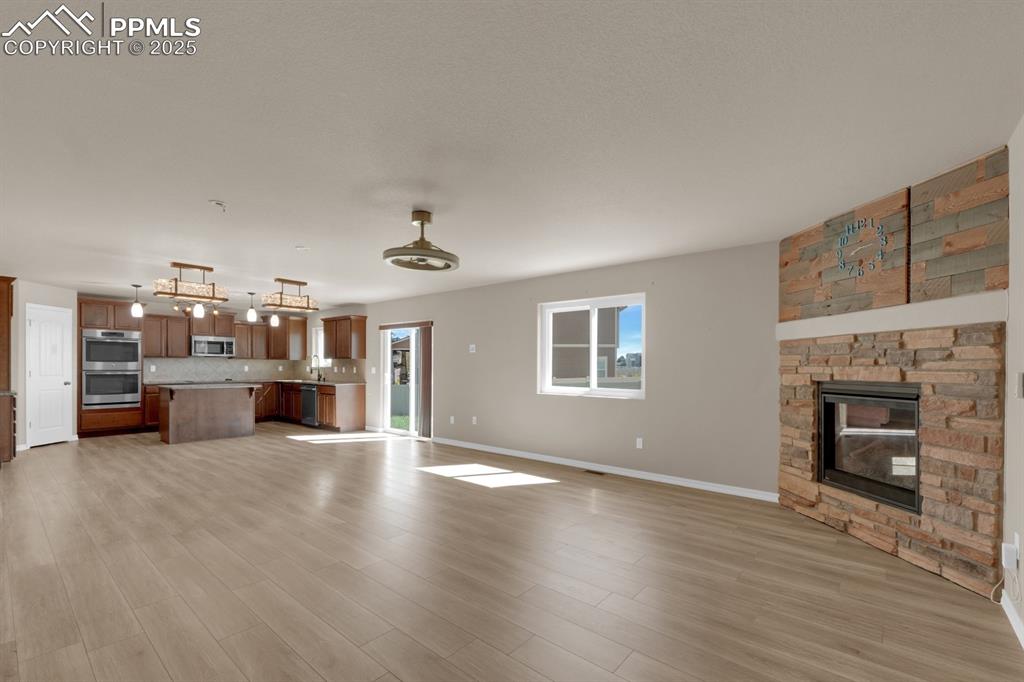 Image 10 of 38: Open concept living room with kitchen