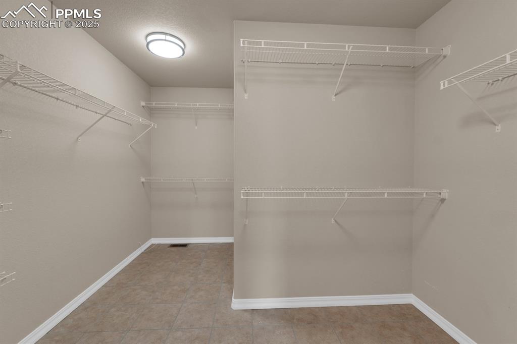 Image 18 of 38: Primary walk-in closet