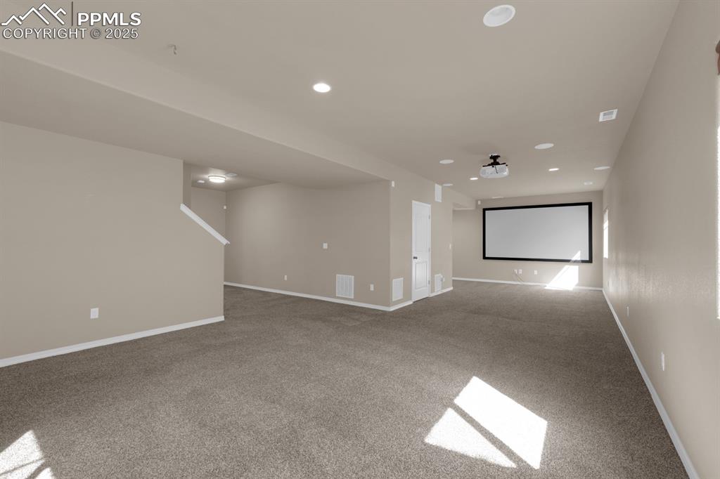 Image 5 of 38: Family room with recessed lighting and home theater options 