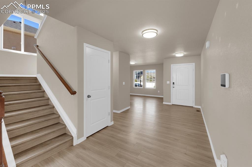 Image 7 of 38: Entryway with light LVP flooring