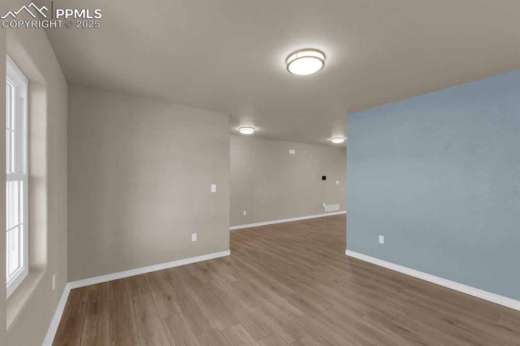 Image 9 of 38: Empty room with light wood-style floors and baseboards