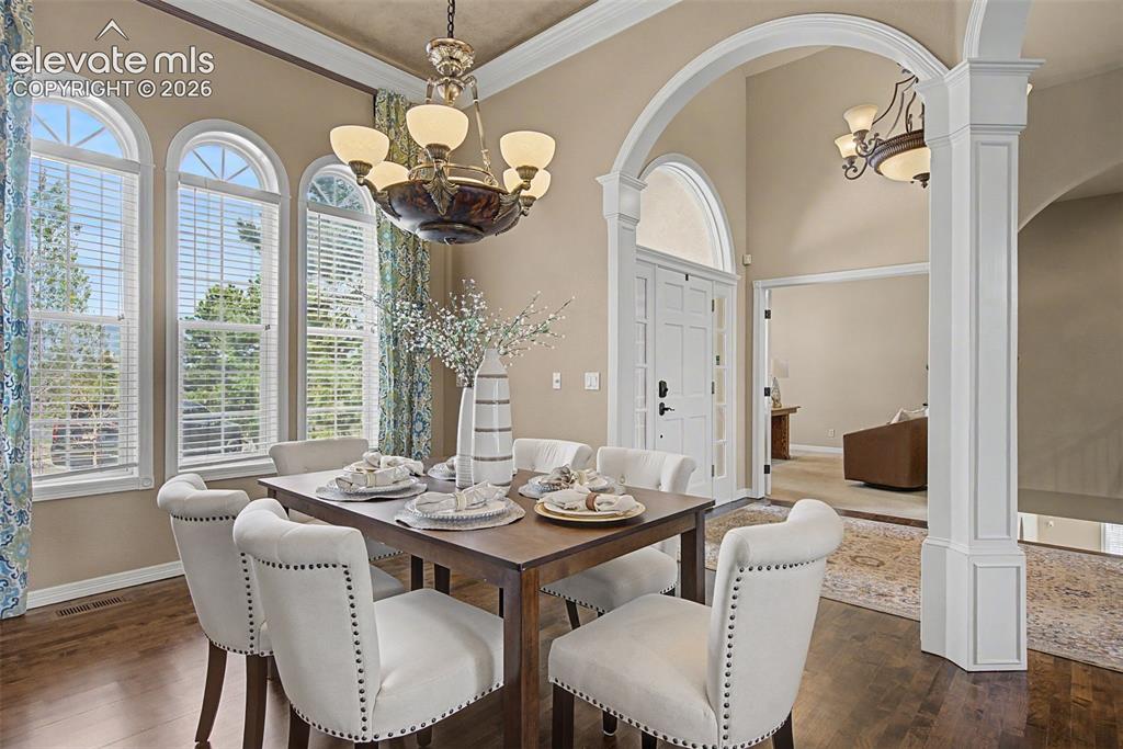 Image 10 of 42: Arched architectural details elevate the formal dining room, providing a re