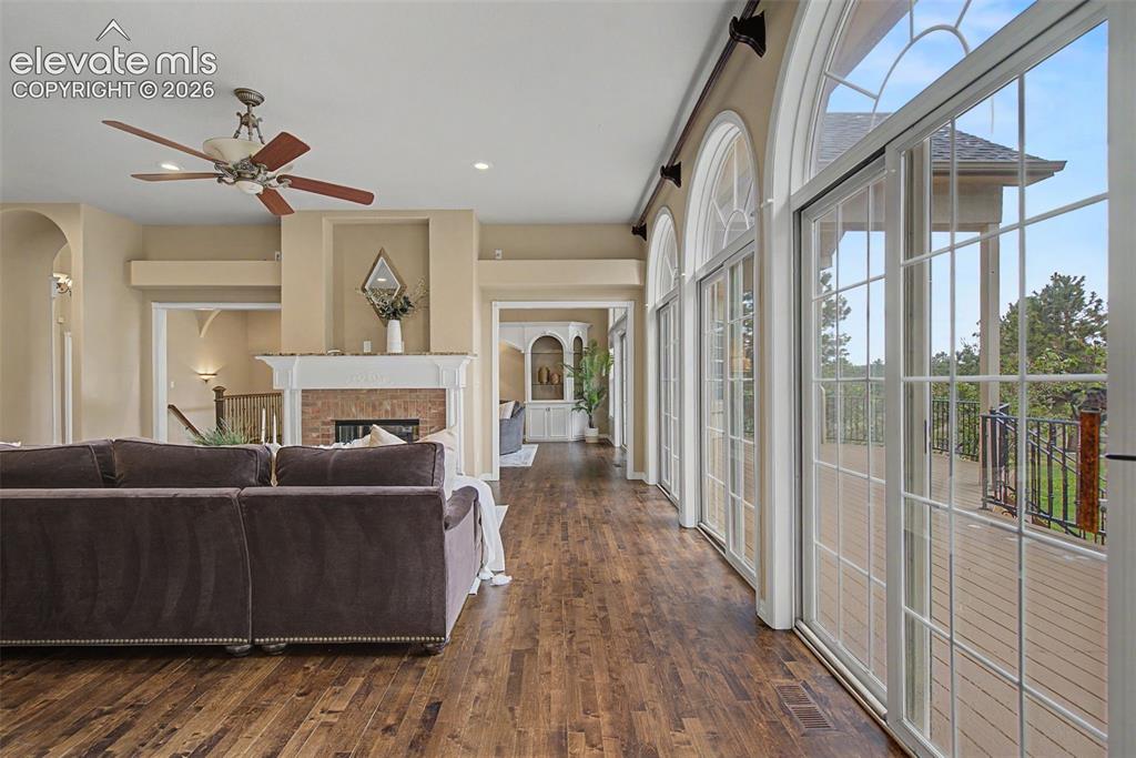 Image 13 of 42: A spectacular wall of glass sliding doors below the arched transoms provide