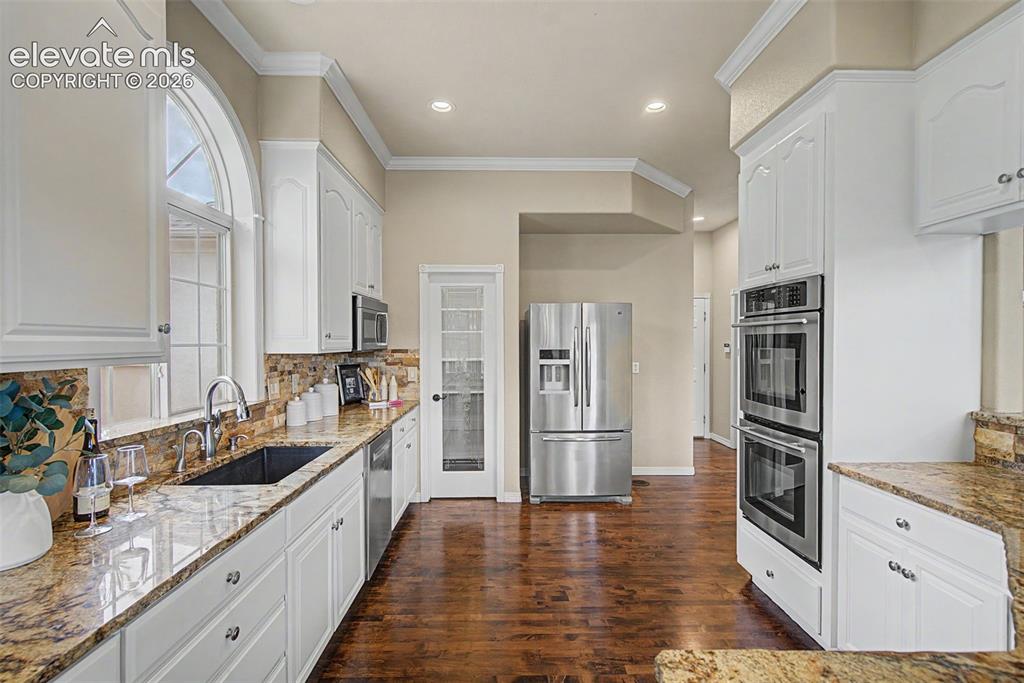 Image 16 of 42: Recessed lighting, premium fixtures, and high-end finishes complete this hi