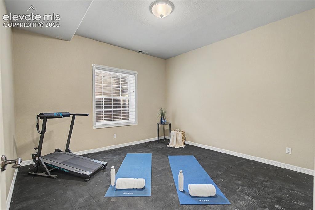 Image 27 of 42: The flexible layout of this spacious room easily accommodates a private hom
