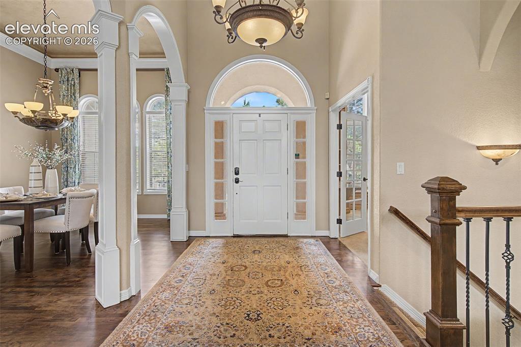 Image 3 of 42: The grand foyer makes a striking first impression, showcasing gleaming hard
