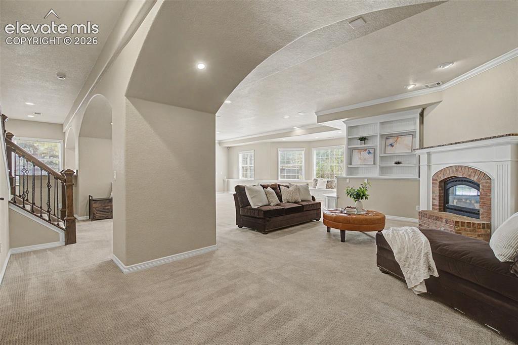 Image 30 of 42: The fully finished walk-out lower level offers a massive family room, cente