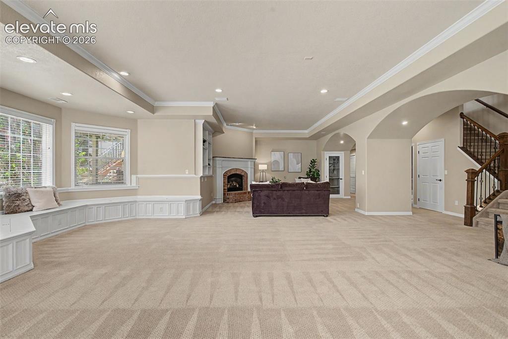 Image 32 of 42: A custom built-in entertainment center and expansive wrap-around window sea