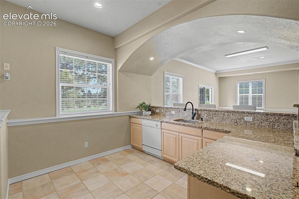Image 34 of 42: The fully equipped wet bar acts as a secondary kitchen space for entertaini