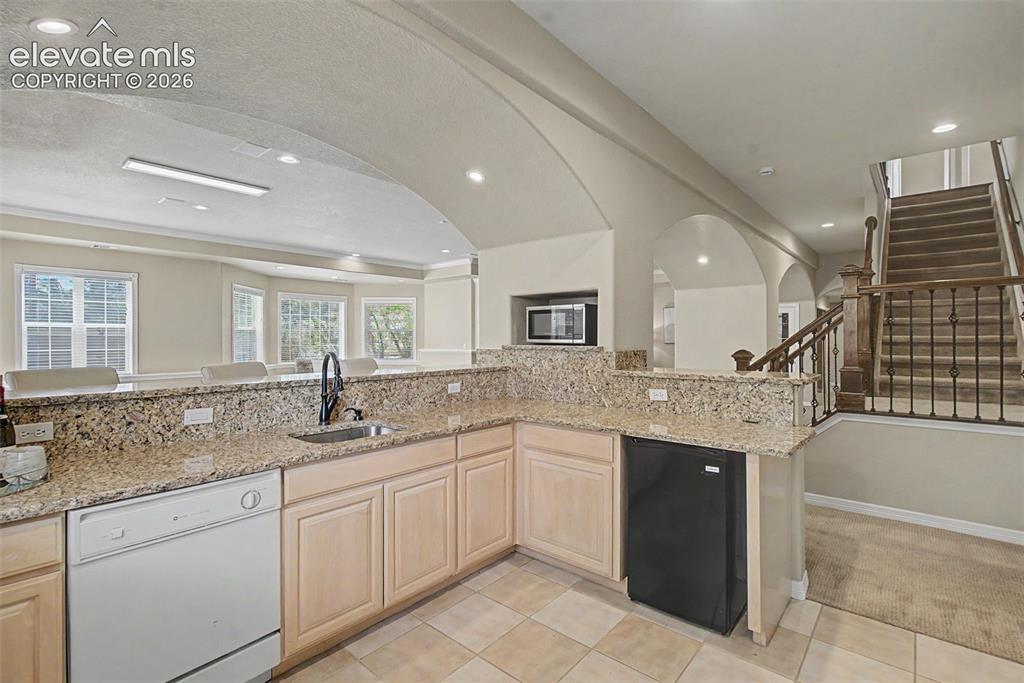 Image 35 of 42: Extensive cabinetry, a mini-fridge, and ample prep space make the lower-le