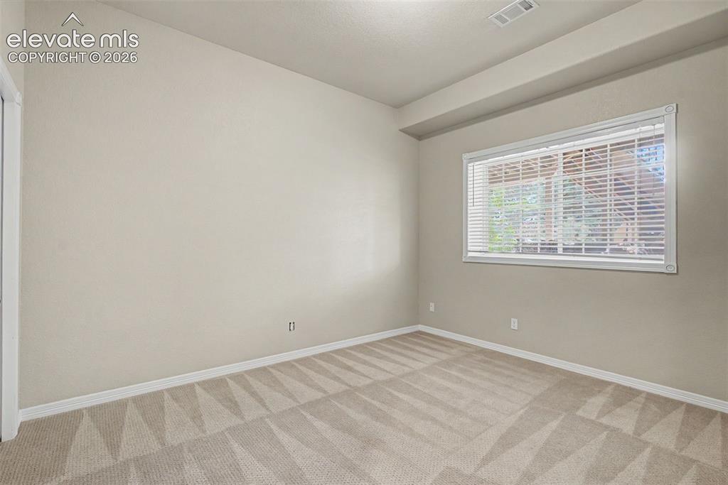 Image 37 of 42: Another bright and spacious basement bedroom demonstrates the home