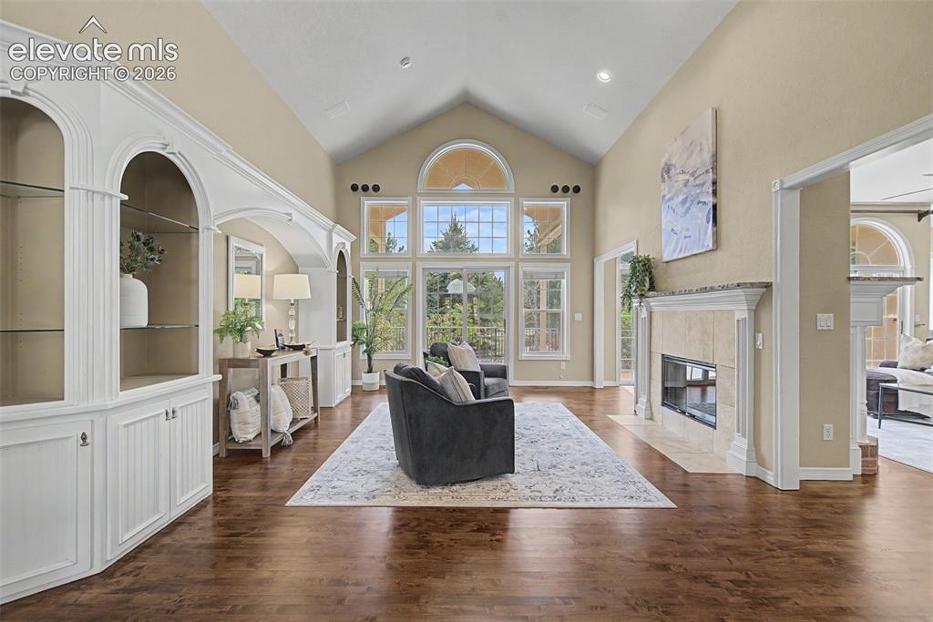 Image 7 of 42: A double-sided gas fireplace anchors the main living area, offering warmth,
