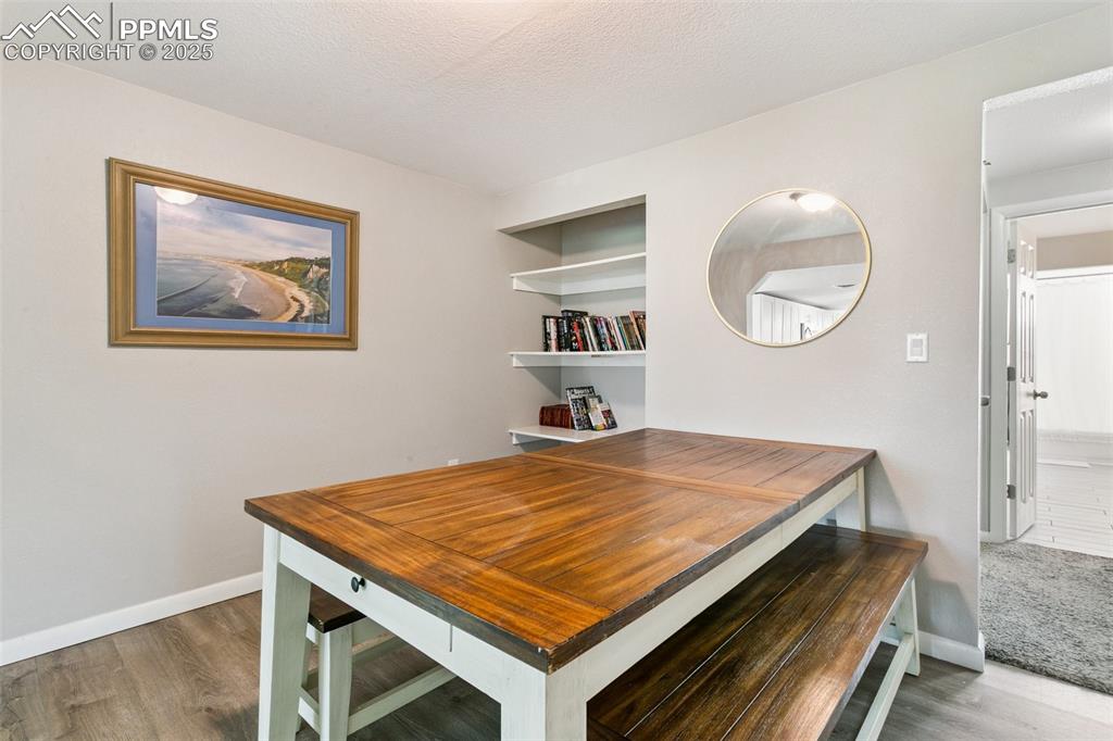 Image 12 of 36: View from the kitchen facing built in shelves