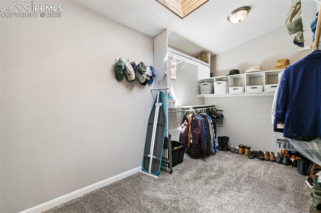 Image 17 of 36: Very large walk in closet with cedar skylight