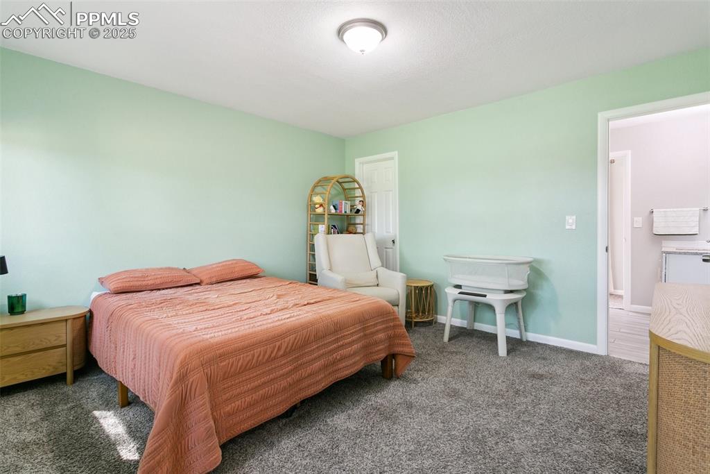 Image 19 of 36: Second bedroom with walk in closet and attached bath