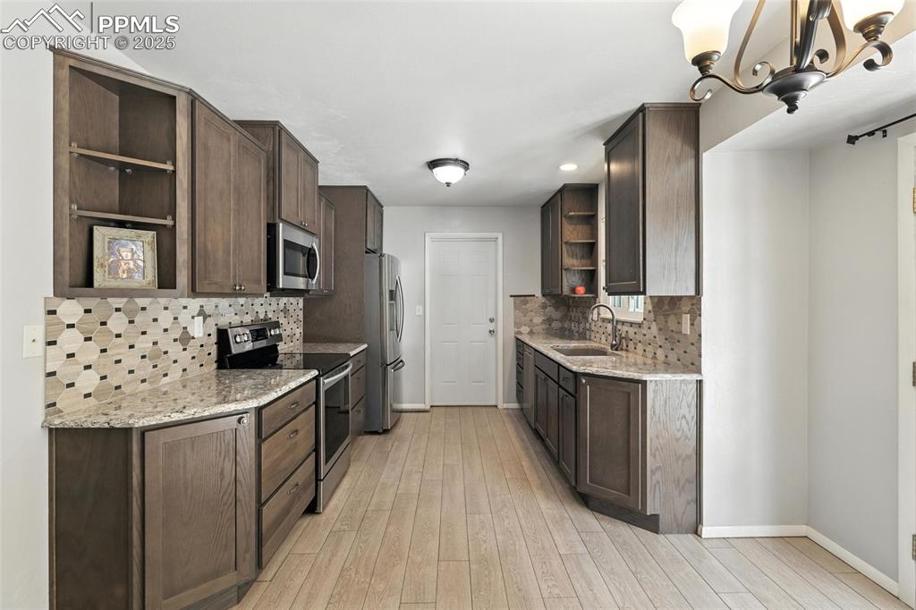 Image 19 of 42: Kitchen Looking Towards the Garage Egress Door