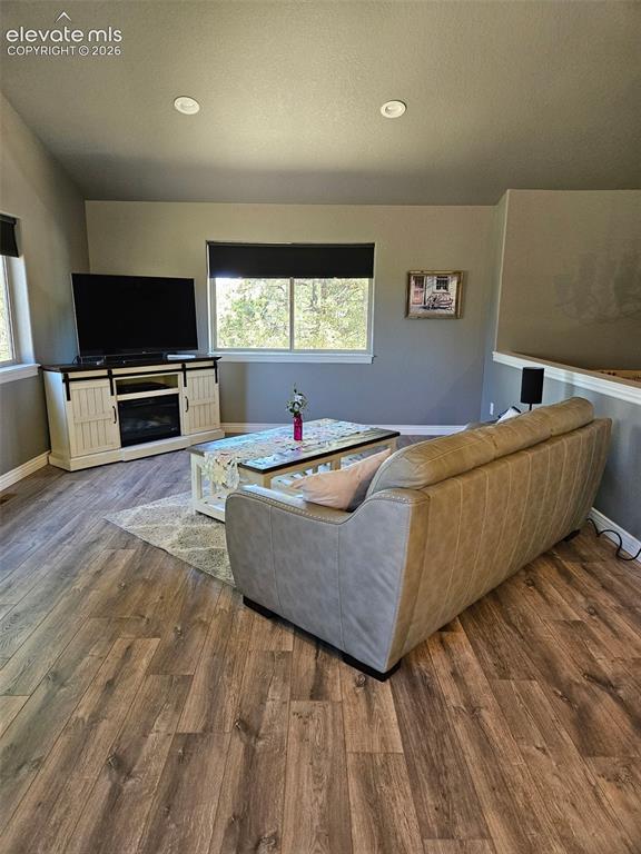Image 12 of 37: Open concept to dining and kitchen. Vaulted ceilings