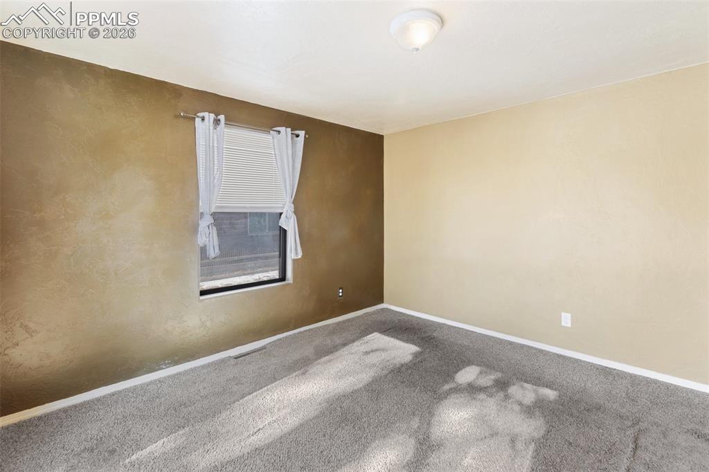 Image 16 of 36: Carpeted empty room with baseboards