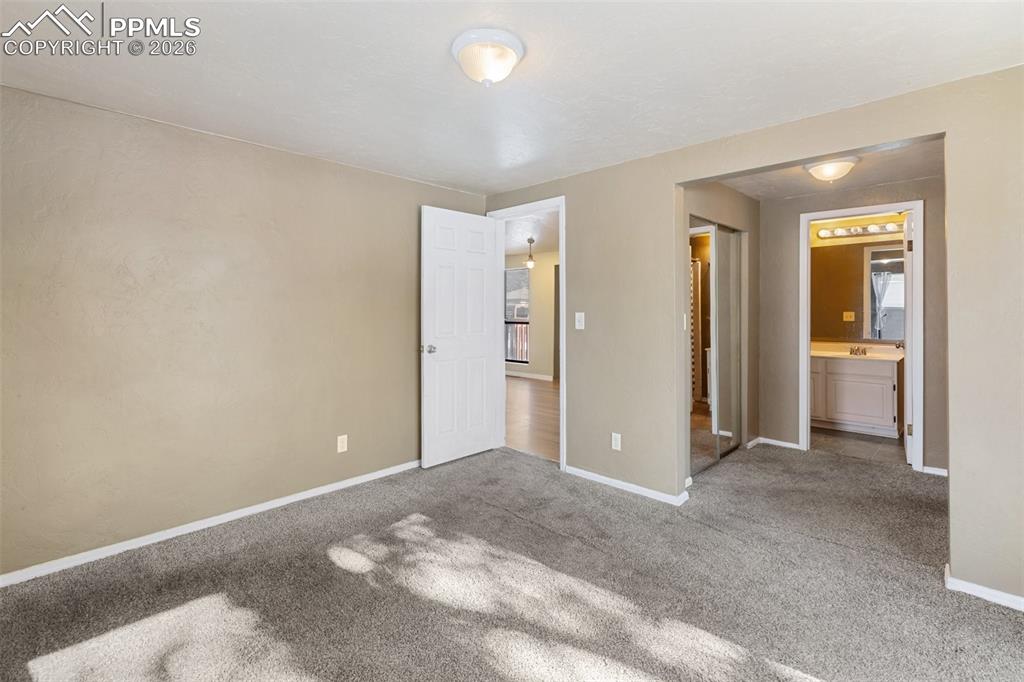 Image 17 of 36: Unfurnished bedroom with a closet and carpet floors