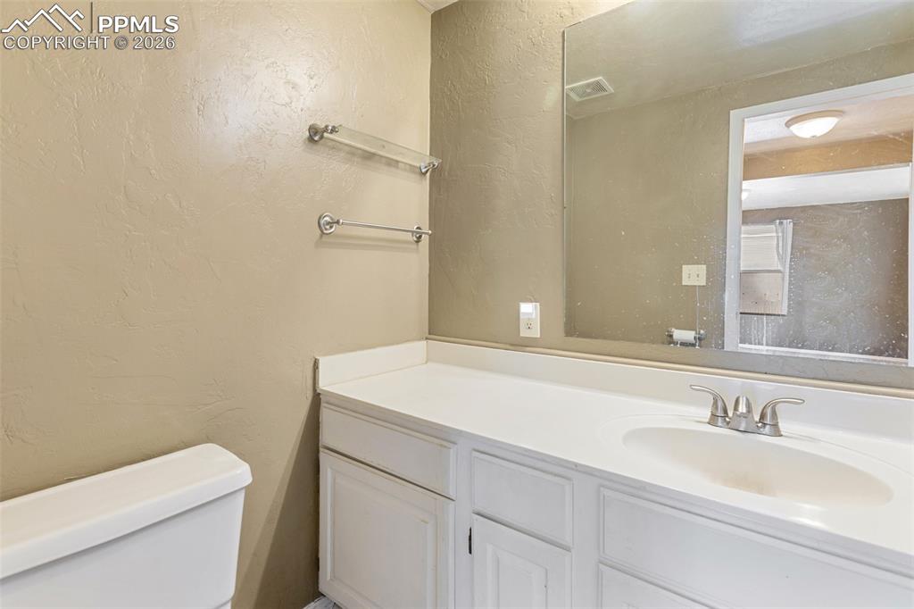 Image 18 of 36: Half bathroom featuring a textured wall and vanity