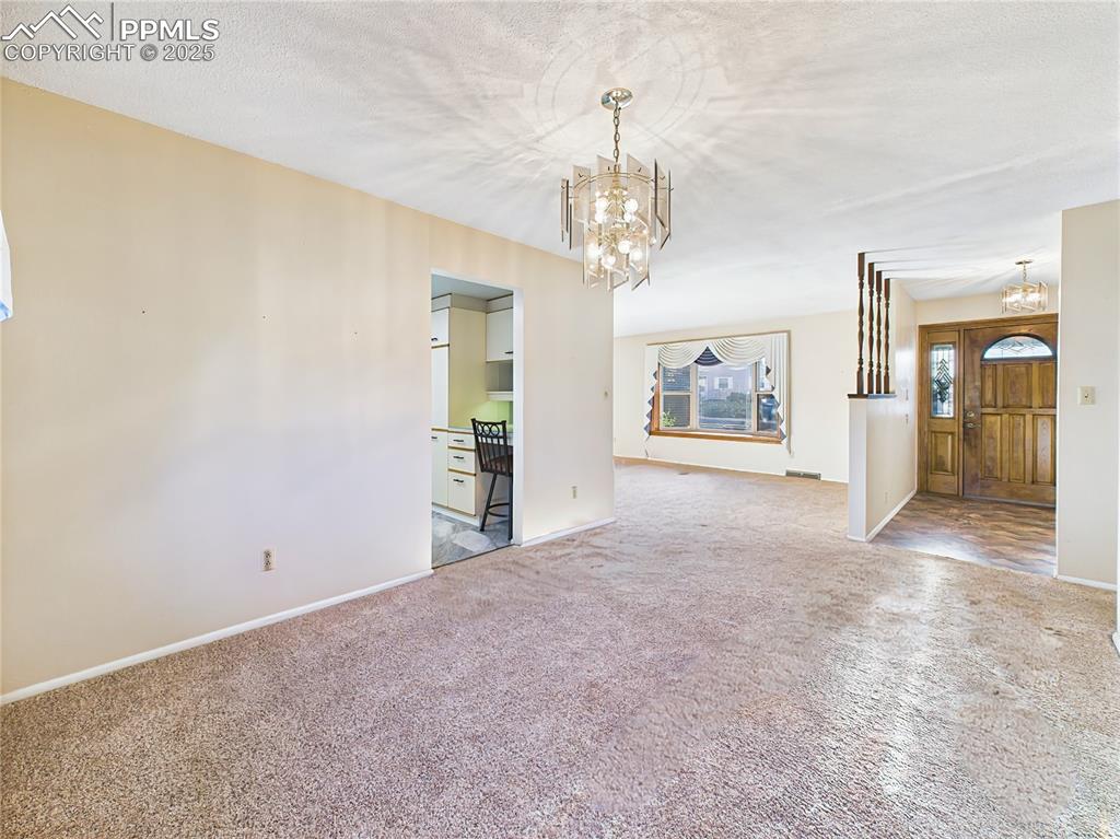 Image 10 of 49: Dining Room Toward Foyer (Empty) – View from the dining room toward the for