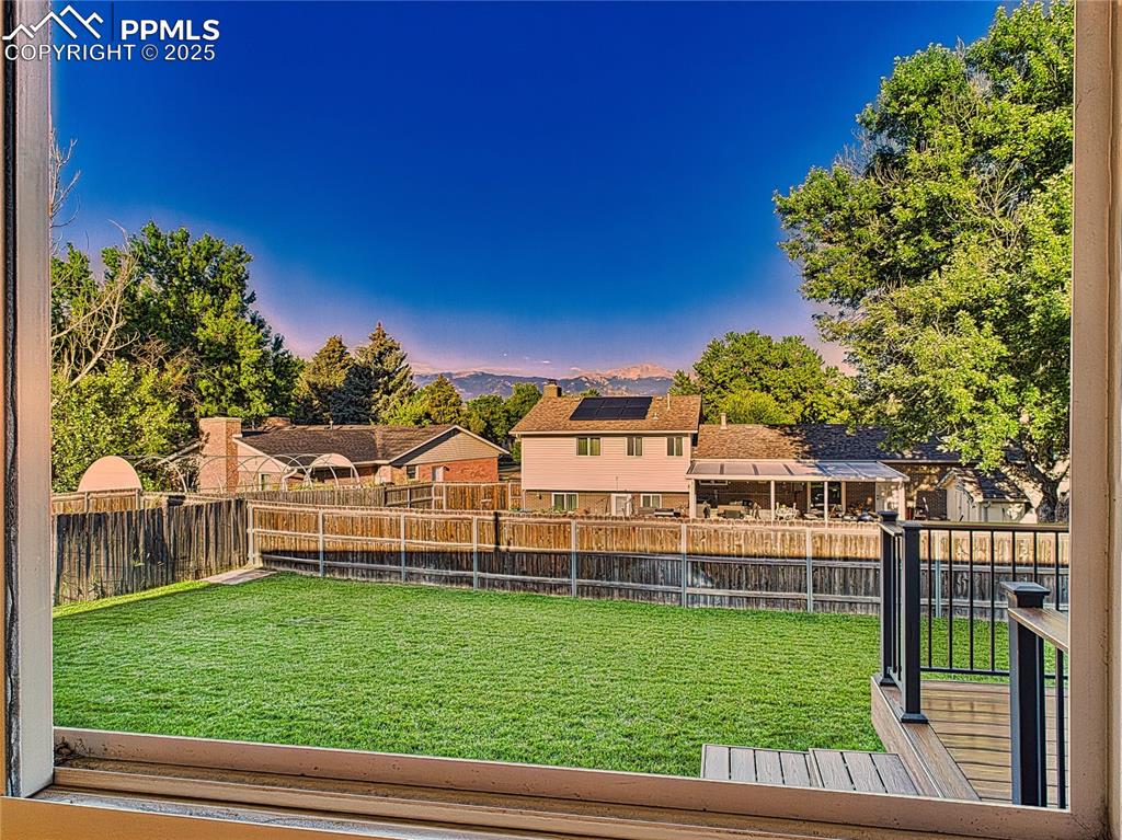 Image 11 of 49: From Dining window Backyard & Deck View – Picture-perfect view of the fence