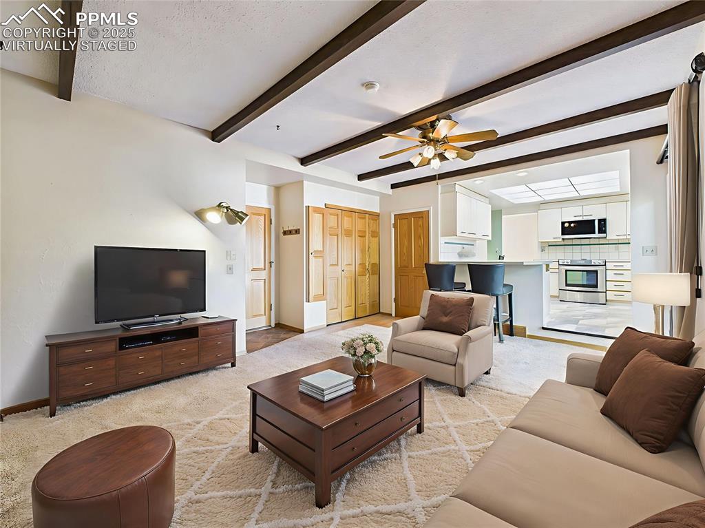 Image 18 of 49: Virtually Staged Family Room brings to life the cozy family room with beame