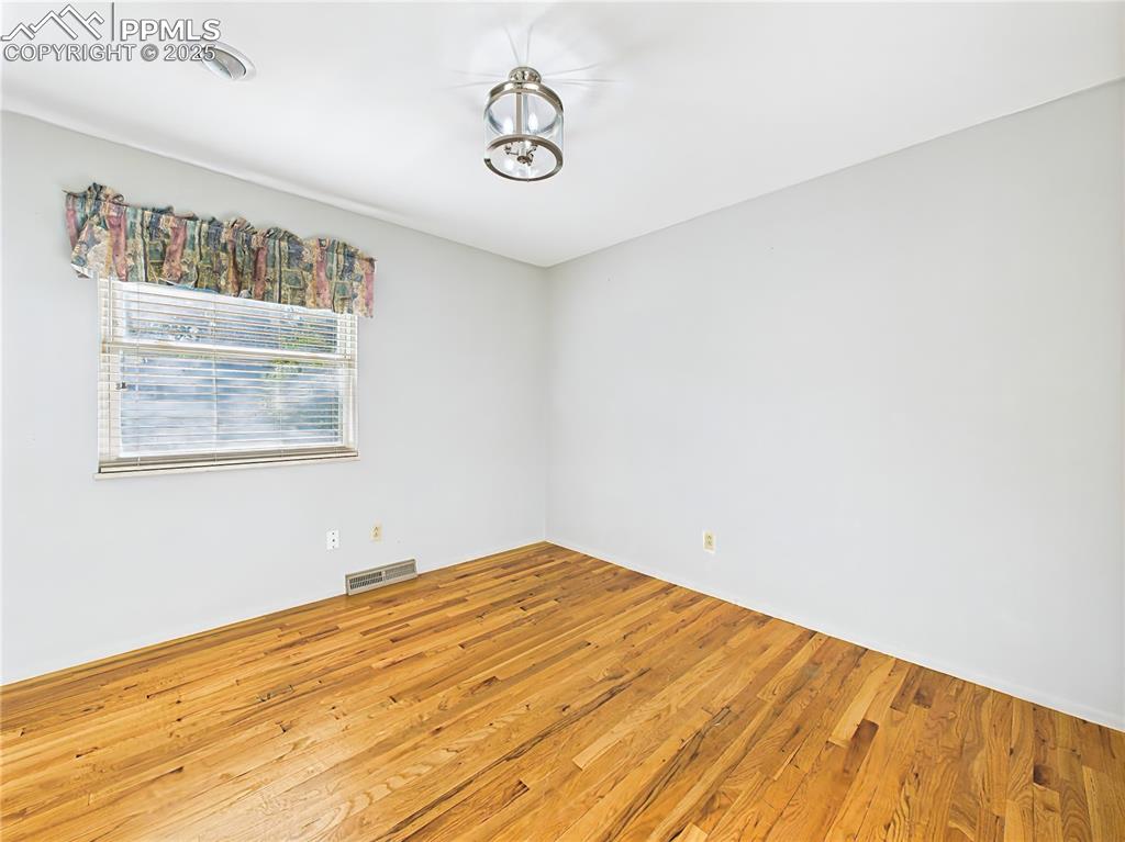 Image 27 of 49: Bedroom 2 (Unfurnished) – With hardwood flooring and great natural light, t