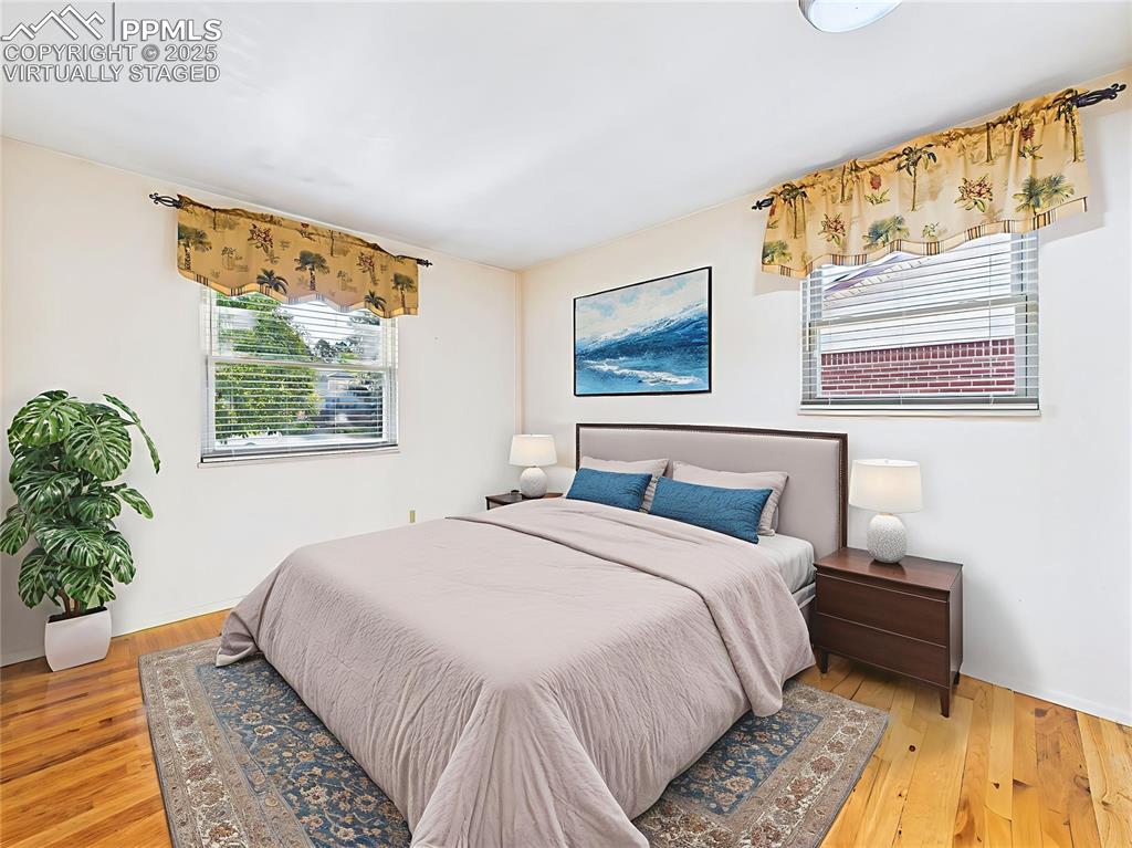 Image 30 of 49: Virtually Staged Bedroom 3 This bedroom includes double-door closets and fr