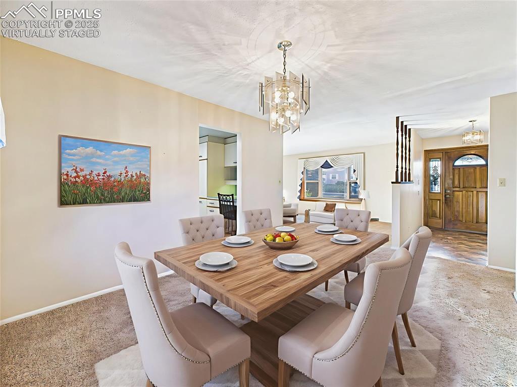Image 9 of 49: Virtually Staged Dining Room Toward Foyer demonstrates the flow between din