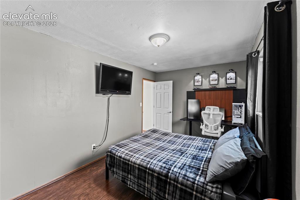 Image 23 of 45: Lower level family room with wood burning fireplace