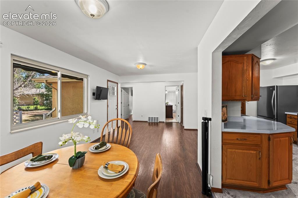 Image 9 of 45: Kitchen featuring wood cabinetry, white countertops, a stainless steel elec