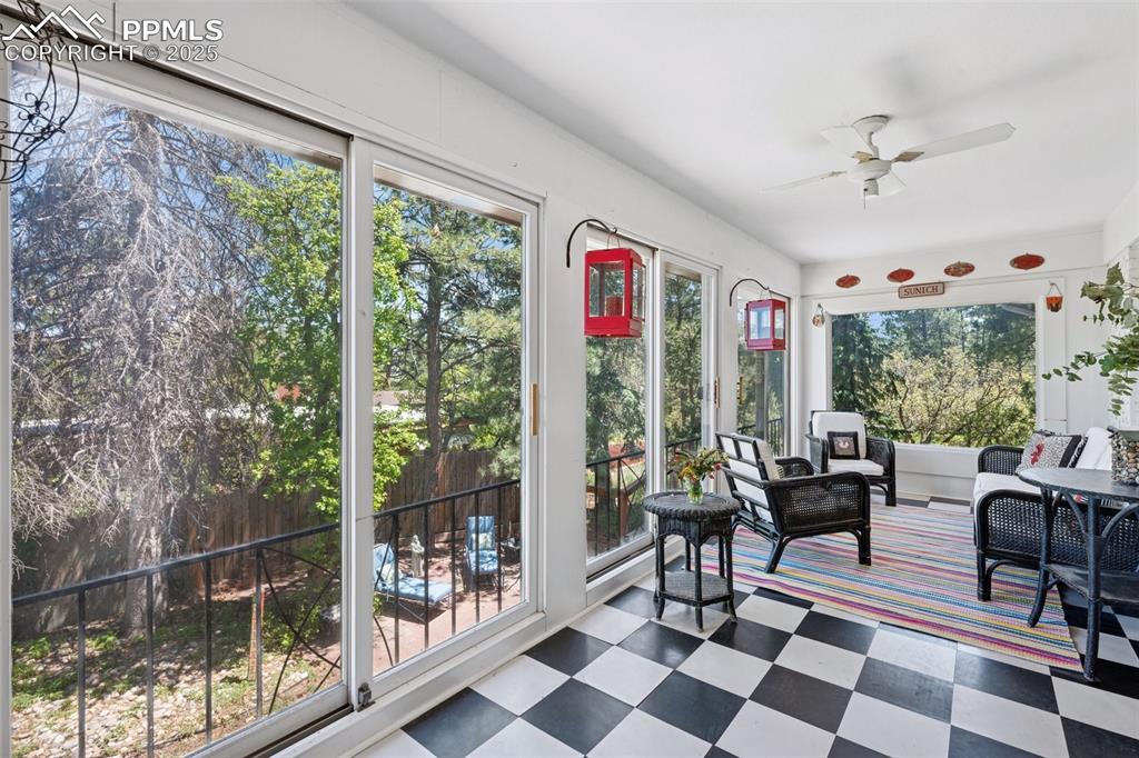 Image 16 of 33: Sunroom / solarium with tile patterned floors and a ceiling fan
