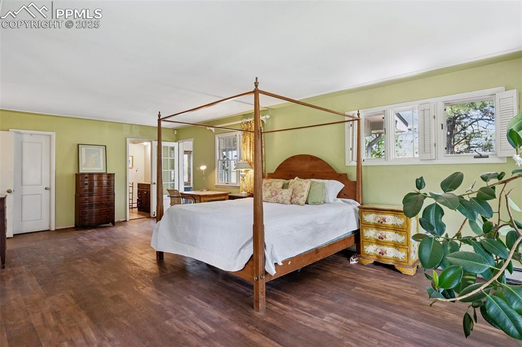 Image 17 of 33: Bedroom featuring multiple windows and wood finished floors
