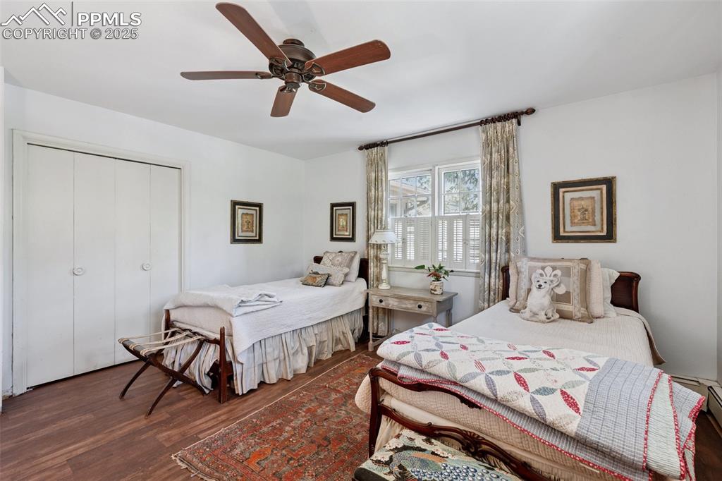 Image 21 of 33: Bedroom featuring a closet, wood finished floors, and a ceiling fan