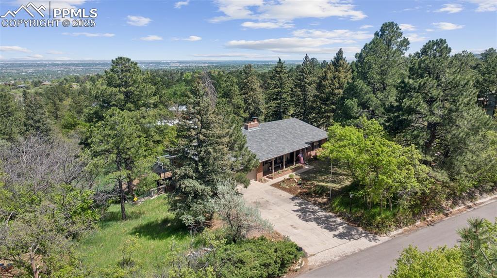 Image 3 of 33: Aerial view of property and surrounding area with a forest