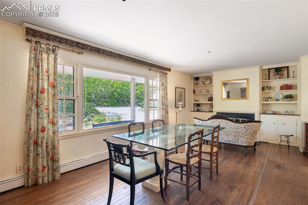 Image 6 of 33: Dining area featuring hardwood / wood-style flooring, a baseboard radiator,