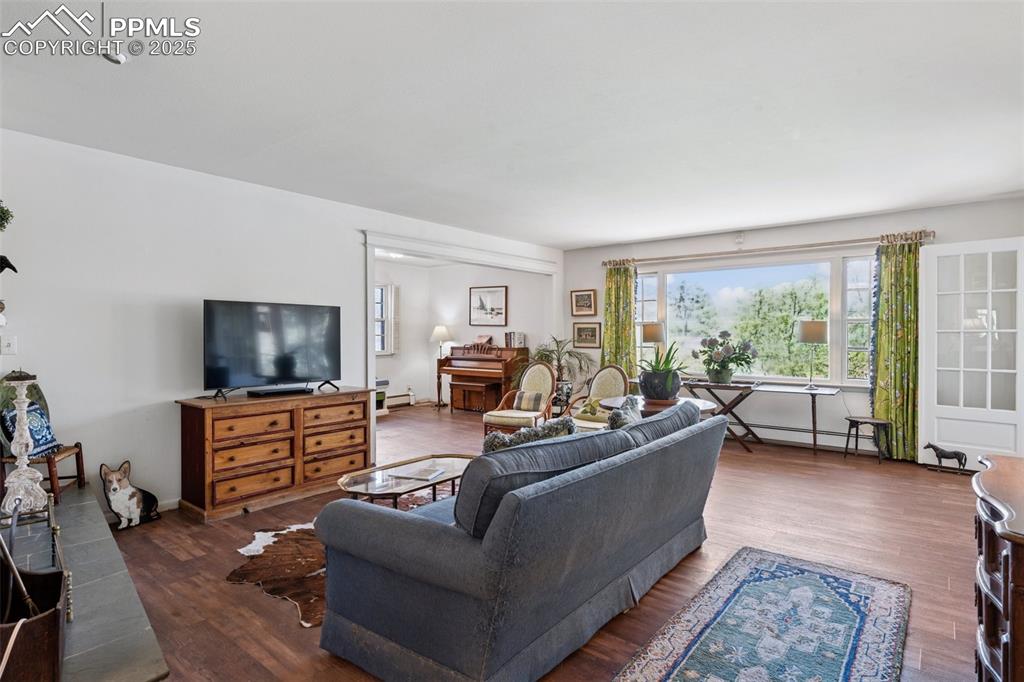Image 8 of 33: Living area featuring wood finished floors
