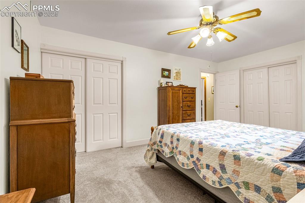 Image 19 of 33: Bedroom with carpet and a ceiling fan