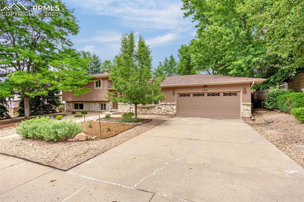 Image 2 of 33: View of front facade featuring concrete driveway, an attached garage, stucc