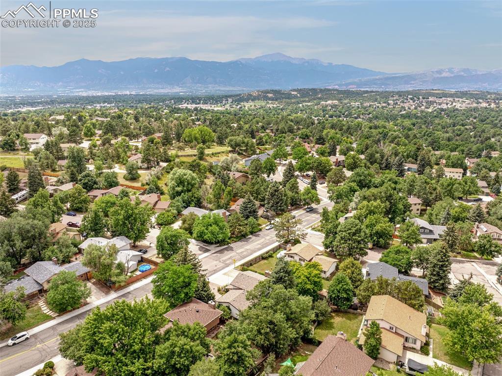Image 30 of 33: Aerial perspective of suburban area with a mountain backdrop