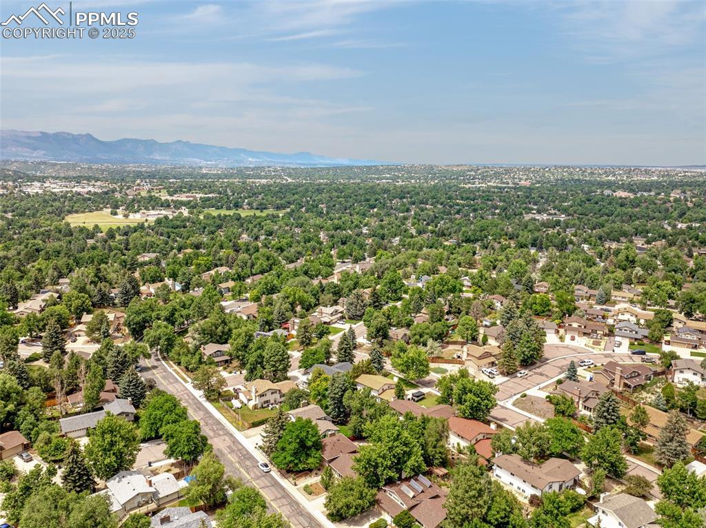 Image 32 of 33: Aerial perspective of suburban area featuring mountains