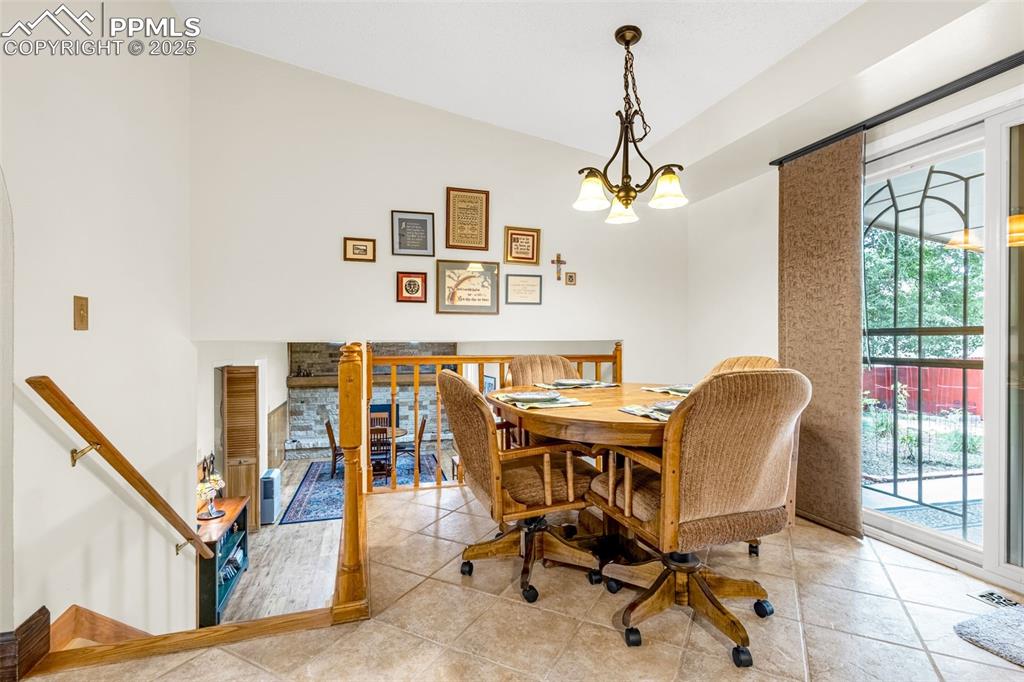 Image 9 of 33: Tiled dining space featuring a chandelier
