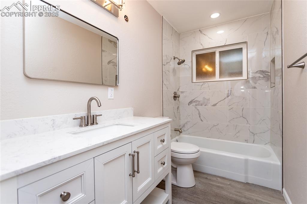 Image 17 of 50: The hall bathroom has a spa feel with beautiful modern finishes.