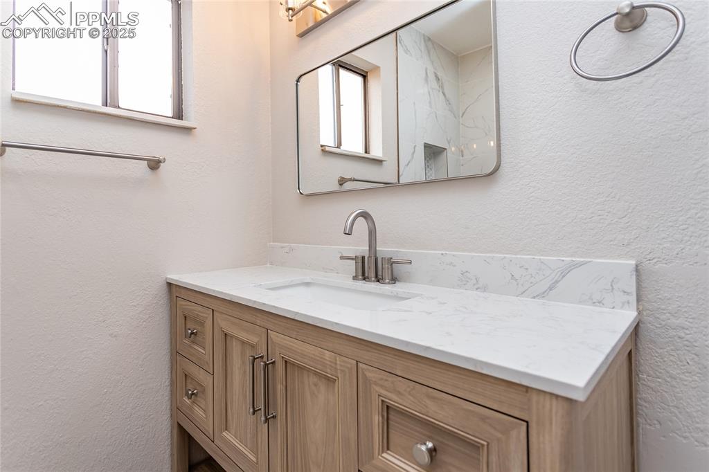 Image 34 of 50: The vanity gives extra storage.